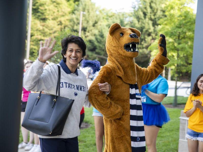 Nittany Lion mascot, left, waves to the crowd with Chancellor Pyati, right